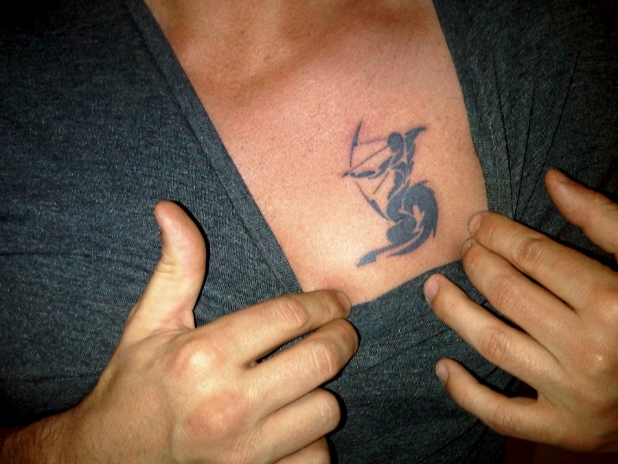 Black ink sagittarius chest tattoo