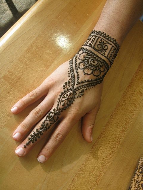 Black mandala style wrist tattoo