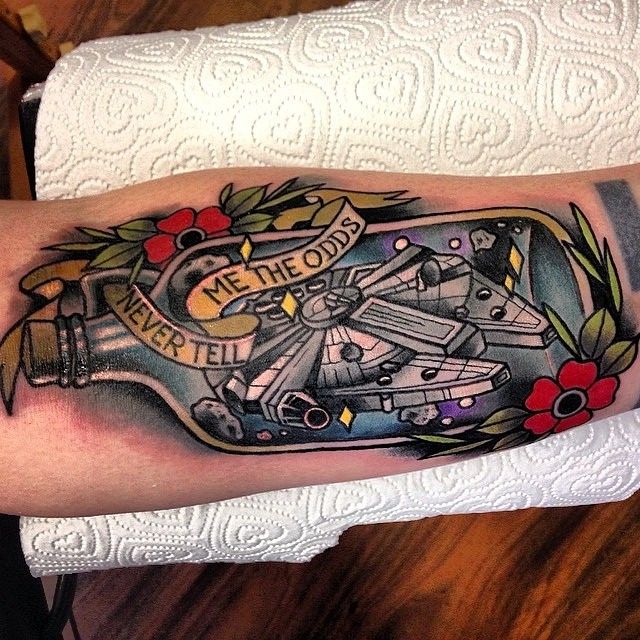 Black ships and planes with red flowers bottle tattoo