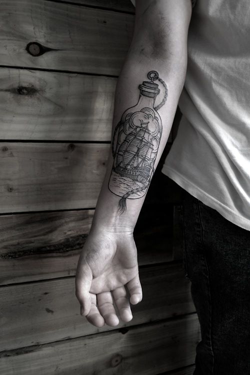 Black ships arm’s bottle tattoo
