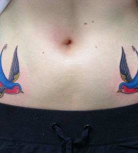 Blue and red swallow tattoo
