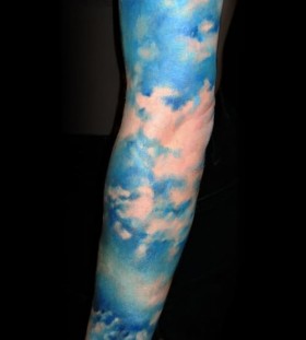 Blue clouds arm tattoo