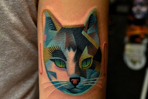 Blue geometric cat tattoo