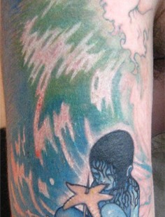 Blue girl with starfish tattoo