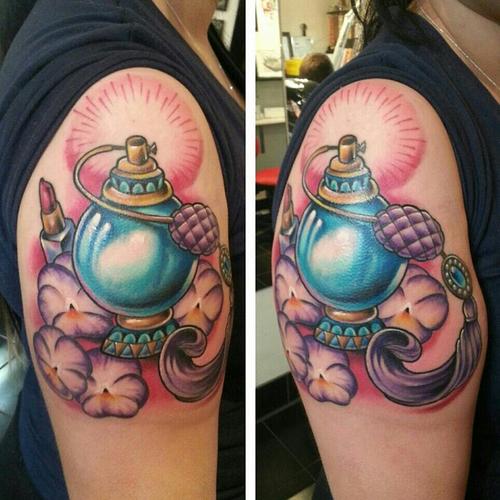 Blue perfume bottle arm tattoo