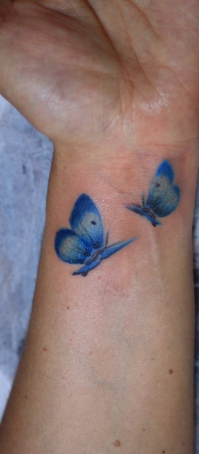 Blue wrist watercolor butterfly tattoo