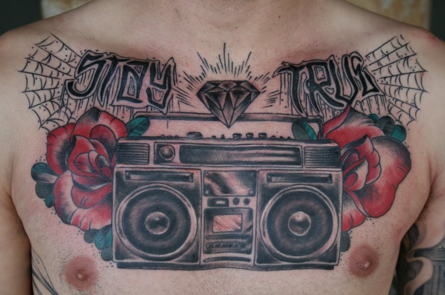 Boombox and roses chest tattoo
