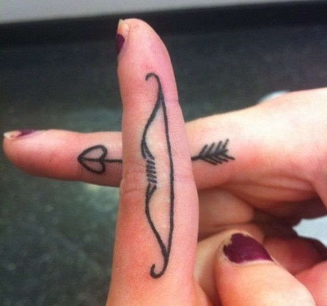 Bow and arrow finger tattoos