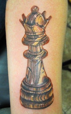 Brown and yellow chess tattoo
