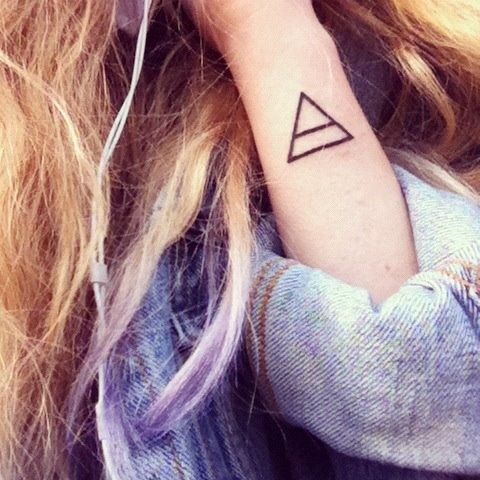 Brown hair and triangle tattoo