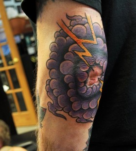Cloud and lightning elbow tattoo