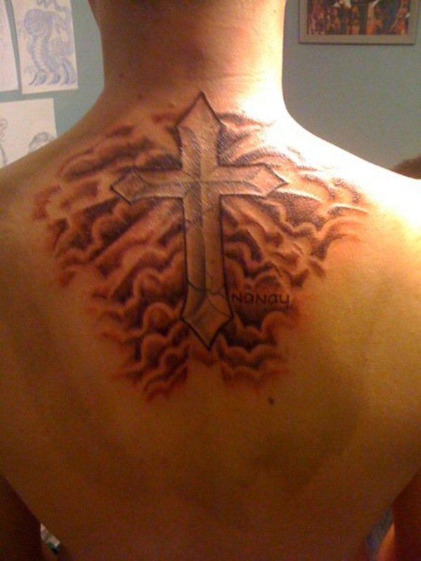 Clouds and cross tattoo