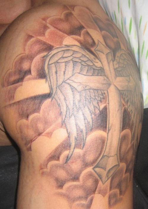 Clouds and cross with wings tattoo