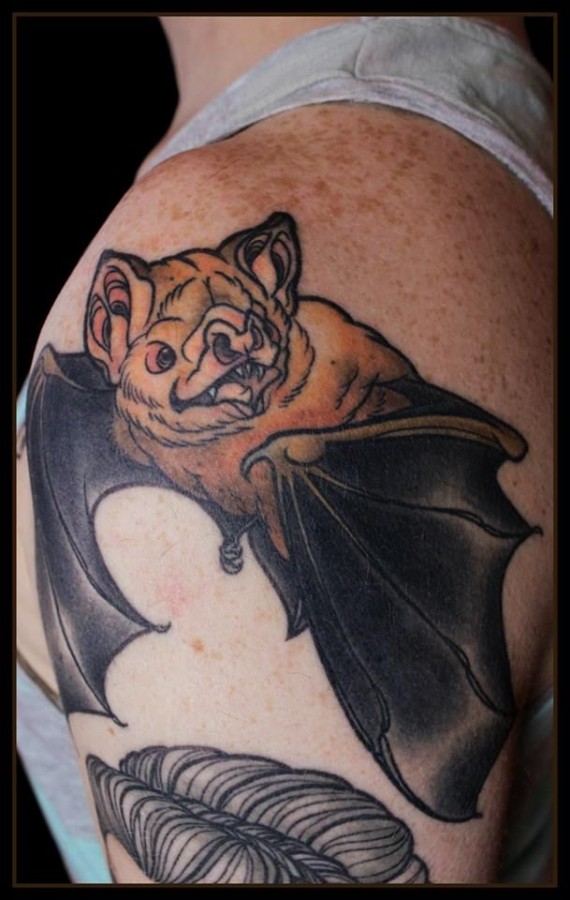 Coloured bat shoulder tattoo