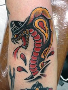 Coloured cobra arm tattoo