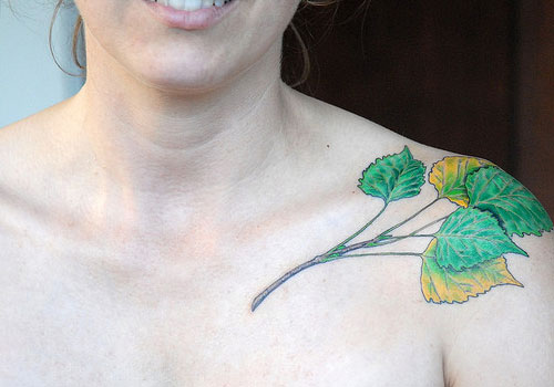 Coloured leaves collarbone tattoo