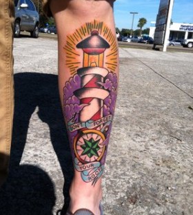Coloured lighthouse leg tattoo