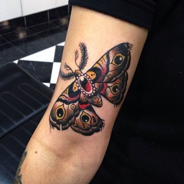 Coloured moth arm tattoo