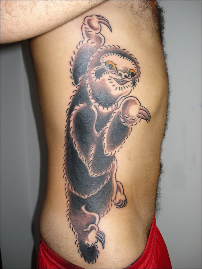 Coloured sloth side tattoo