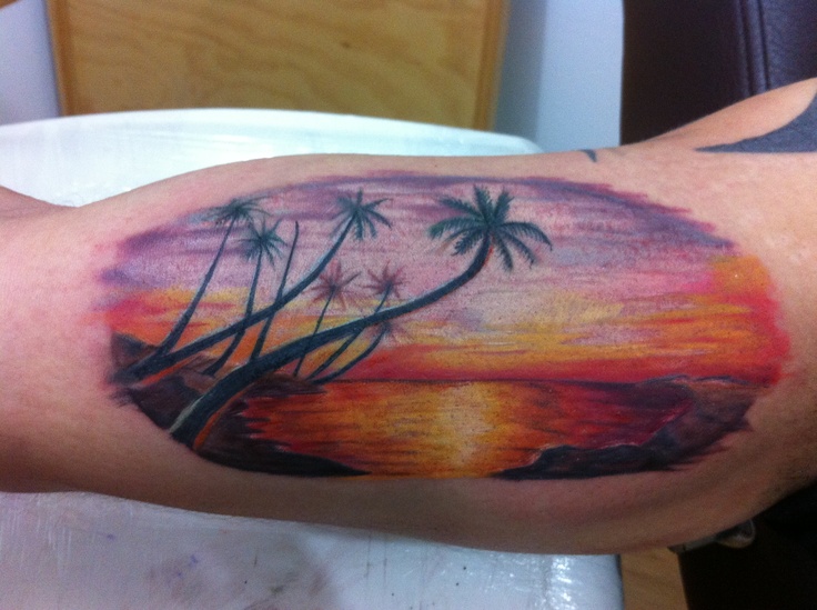Coloured sunset arm tattoo