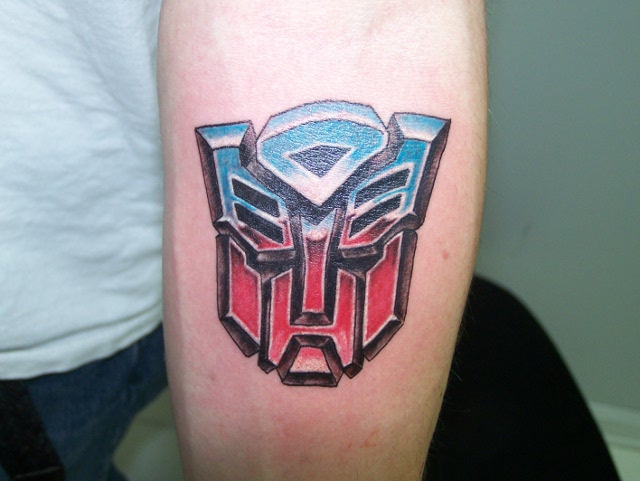 Coloured transformers logo tattoo