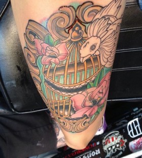 Colourful birdcage and bird tattoo