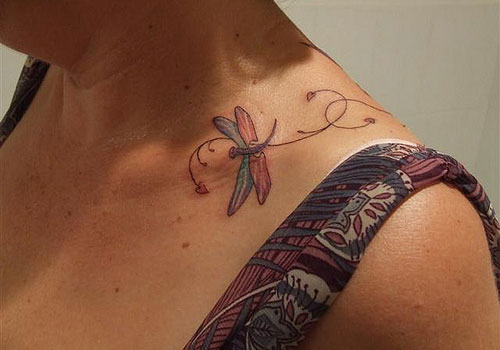 Colourful dragonfly collarbone tattoo
