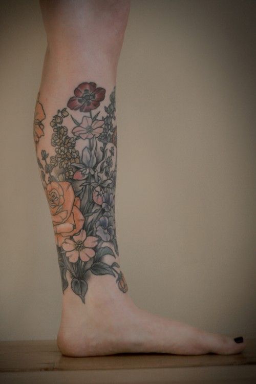Colourful flowers leg tattoo by Kirsten Holliday