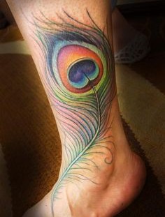 Colourful peacock feather tattoo by Jessica Brennan