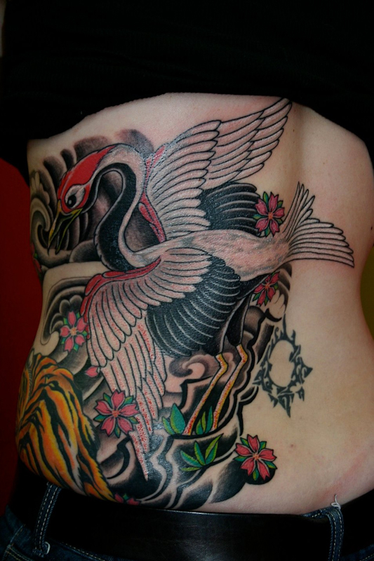 Cool crane and flowers tattoo