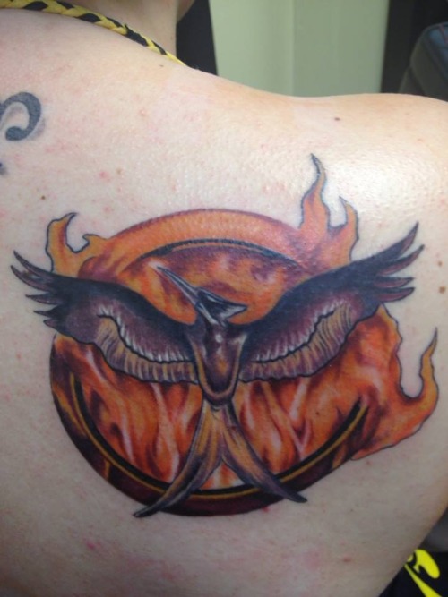 Cool flaming mockingjay back tattoo