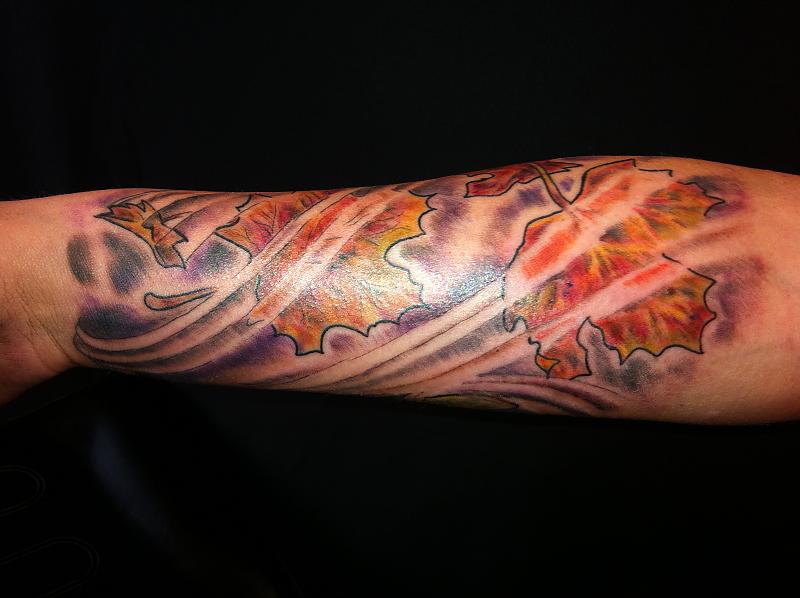 Cool maple leaves arm tattoo