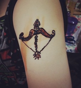 Creative bow and arrow tattoo