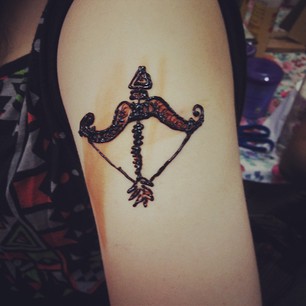 Creative bow and arrow tattoo