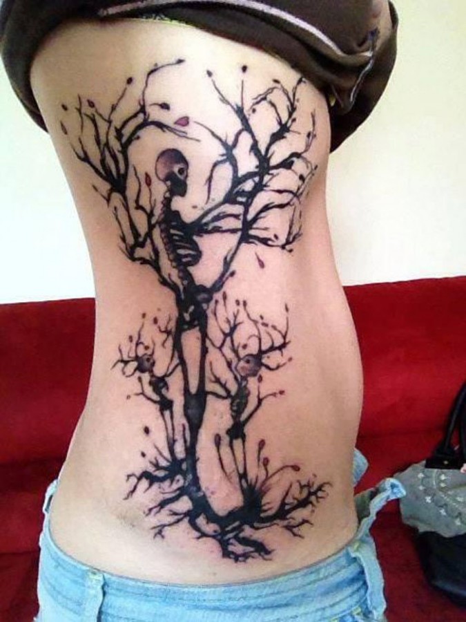 Creative skeleton dead tree tattoo