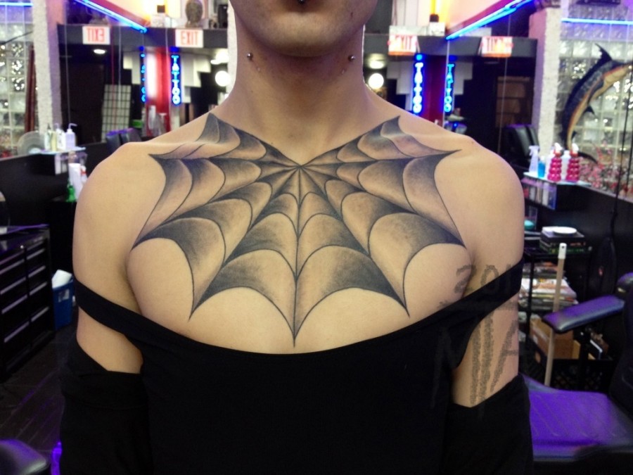 Creative spider web chest tattoo