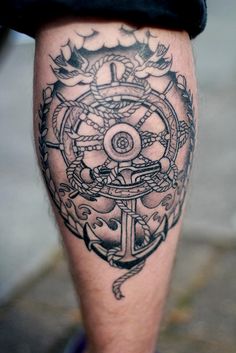 Creative wheel and anchor tattoo
