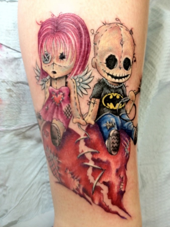 Creepy doll and broken heart tattoo