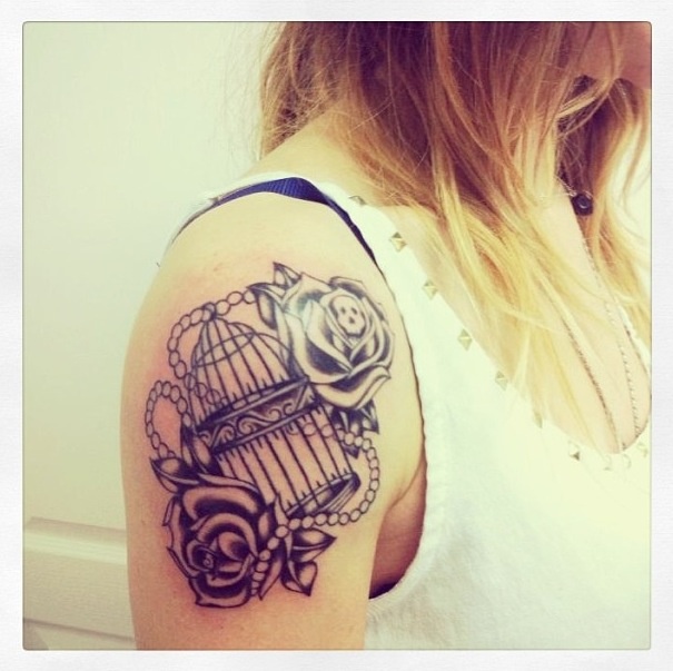 Cute birdcage arm tattoo