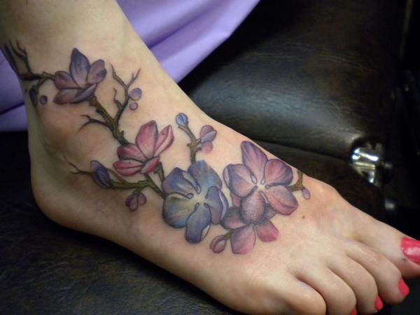 Cute flowers foot tattoo by Amanda Leadman