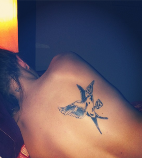 Cute mockingbird back tattoo