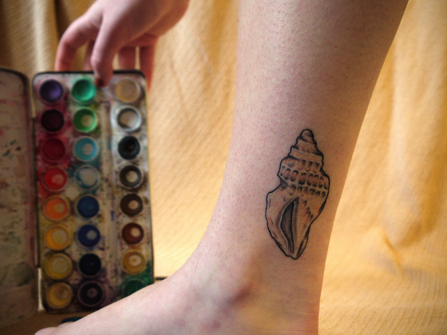 Cute sea shell leg tattoo