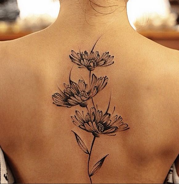 Daisies back tattoo by Chen Jie