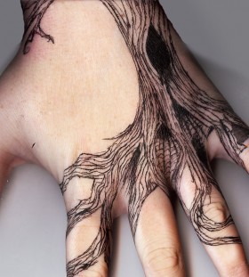 Dead tree hand tattoo