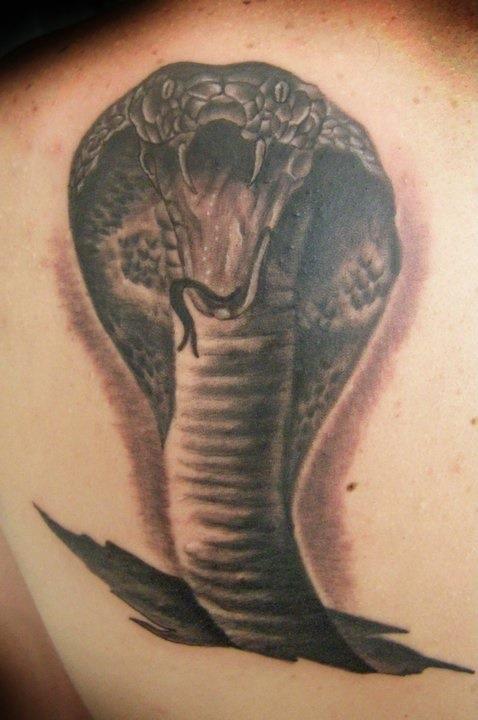Deadly biting cobra tattoo