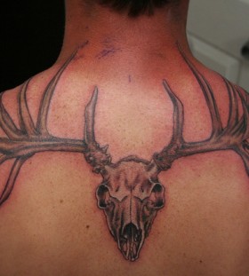 Deer skull back tattoo