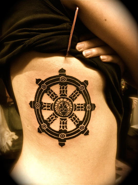 Dharma wheel side tattoo