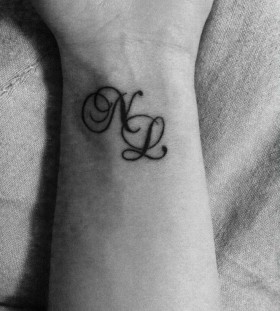 Double letters wrist tattoo