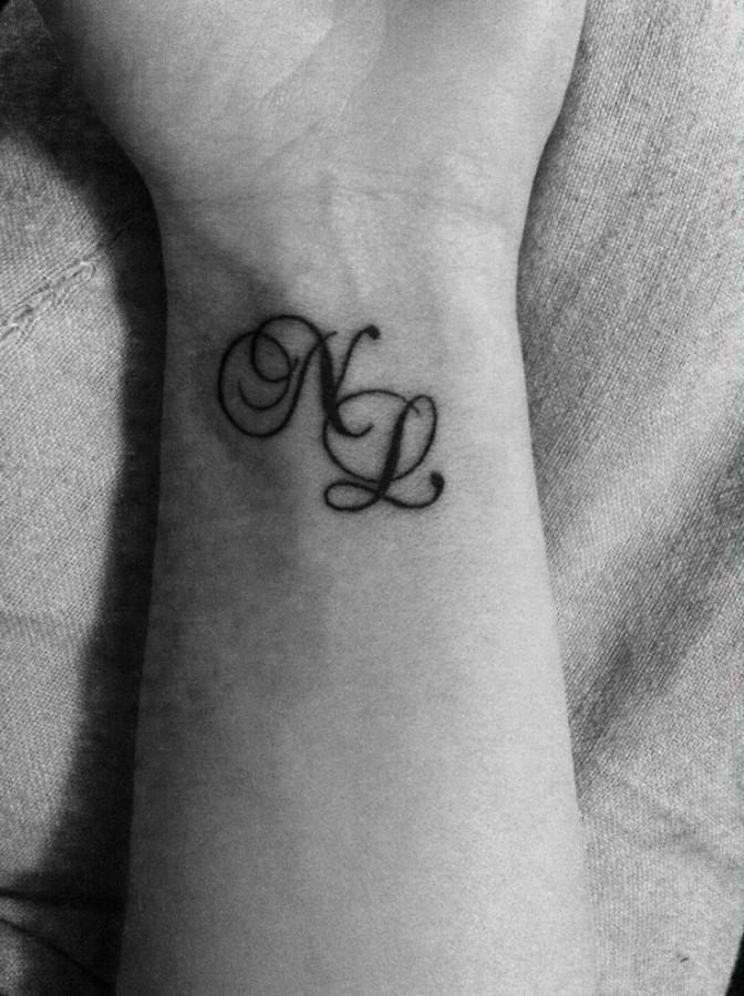 Double letters wrist tattoo