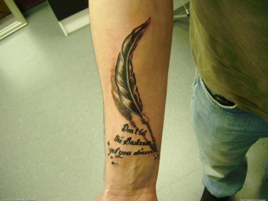 Feather pen and quote arm tattoo